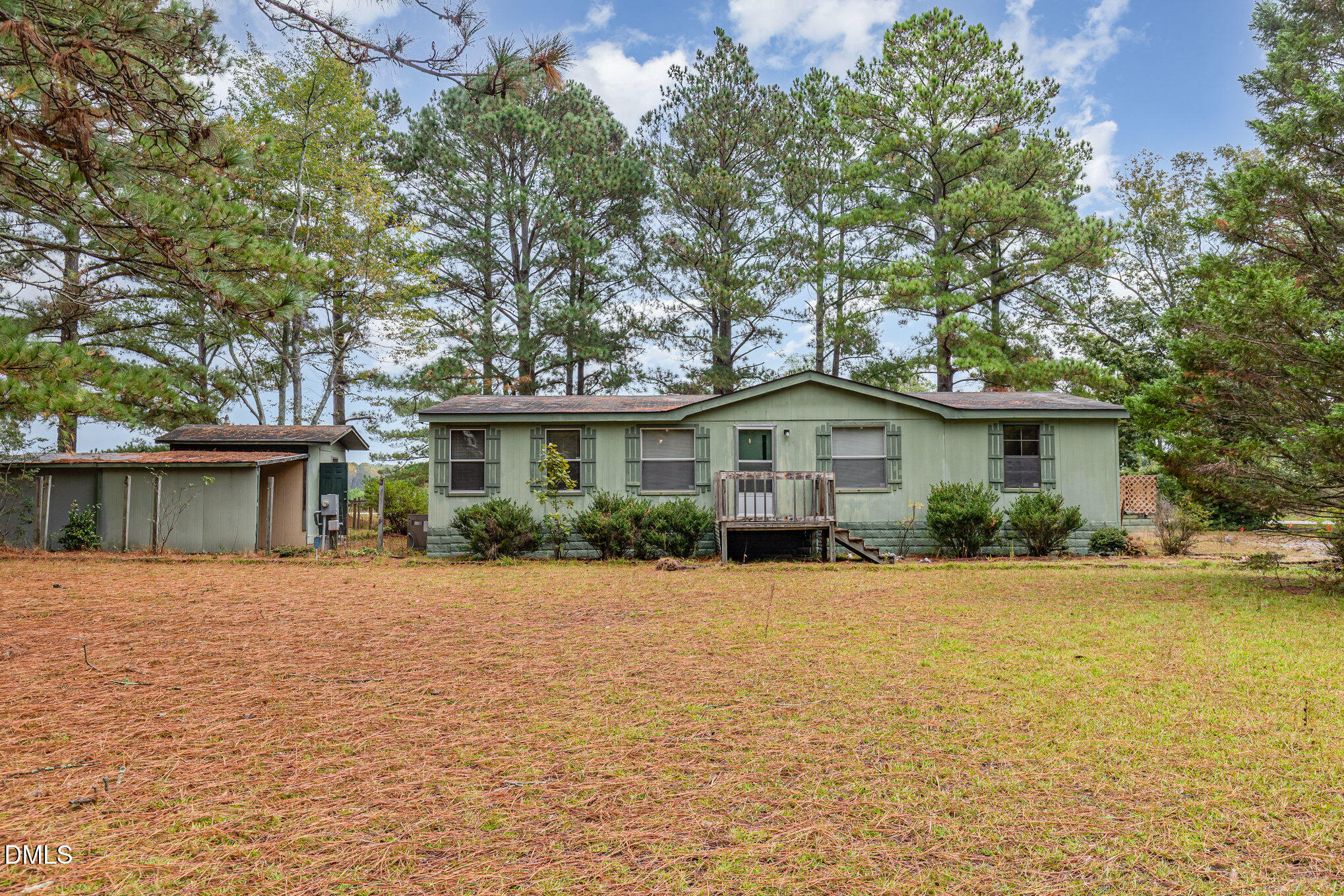1969 Bagley Road Kenly, NC 27542 - Photo 3 of 23 a front view of a house with a yard and trees