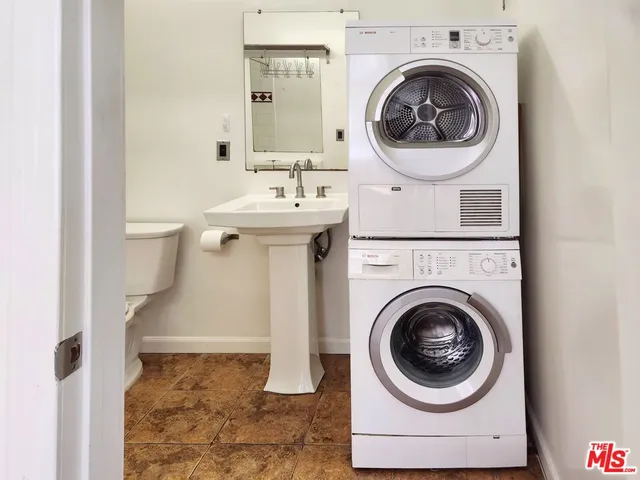 a utility room with sink dryer and washer