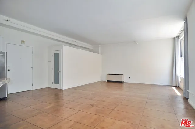 an empty room with a empty space and windows