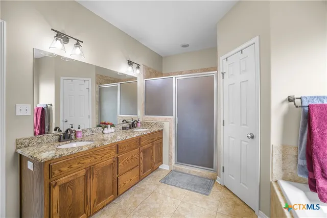 a bathroom with a double vanity sink mirror and double