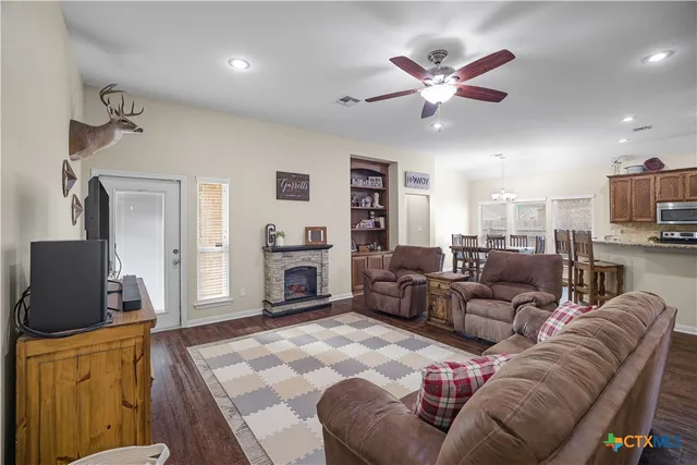 a living room with furniture fireplace and a flat screen tv