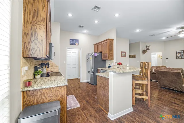 a kitchen with a sink cabinets and wooden floor