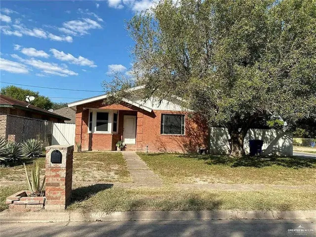 a large tree in front of a house