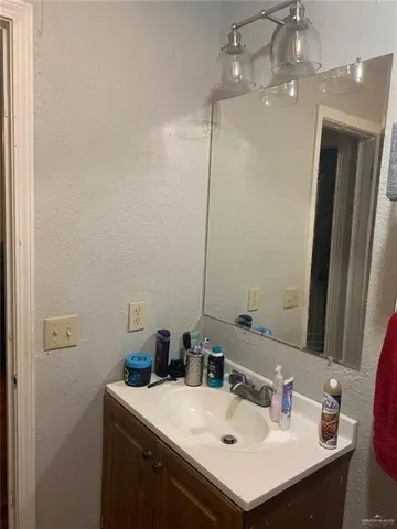 a bathroom with a sink vanity and a mirror