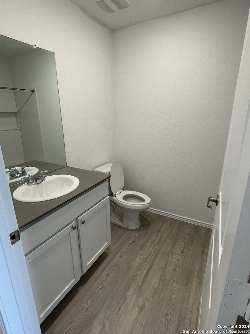 a bathroom with a sink toilet and vanity