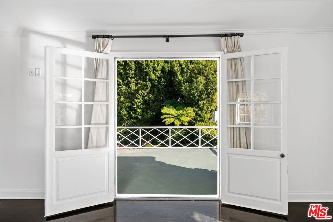 1910 Outpost Drive Los Angeles, CA 90068 - Photo 15 of 27 a view of a door and wooden floor in a room