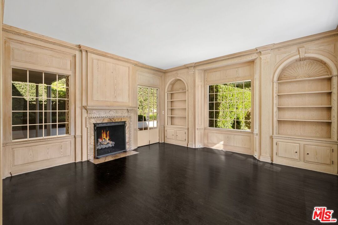 1910 Outpost Drive Los Angeles, CA 90068 - Photo 7 of 27 a view of a livingroom with wooden floor a fireplace and windows