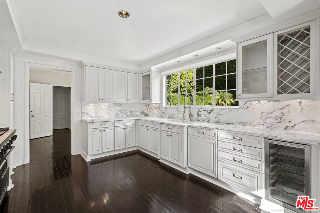 1910 Outpost Drive Los Angeles, CA 90068 - Photo 9 of 27 a kitchen with granite countertop white cabinets and white appliances with wooden floor