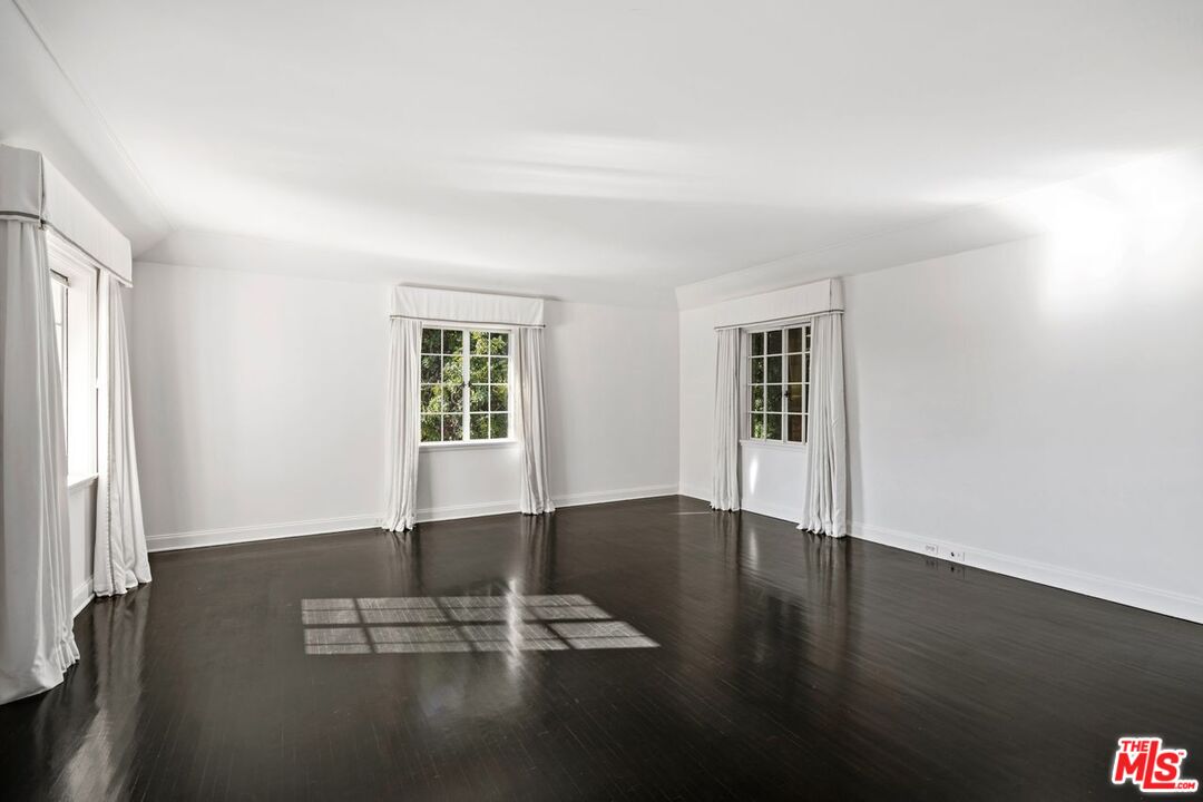 1910 Outpost Drive Los Angeles, CA 90068 - Photo 10 of 27 a view of empty room with wooden floor and fan