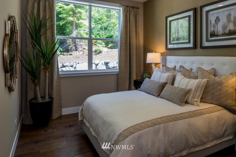 5633 196th Street Southeast, Unit 31 Bothell, WA 98012 - Photo 12 of 25 a bedroom with a bed lamp and a large window