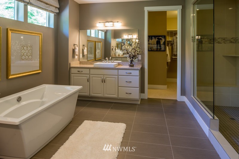 5633 196th Street Southeast, Unit 31 Bothell, WA 98012 - Photo 18 of 25 a bathroom with a tub a sink and a large mirror