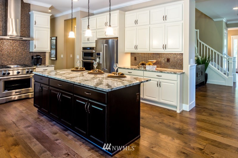 5633 196th Street Southeast, Unit 31 Bothell, WA 98012 - Photo 9 of 25 a kitchen with stainless steel appliances granite countertop a stove a sink and a refrigerator