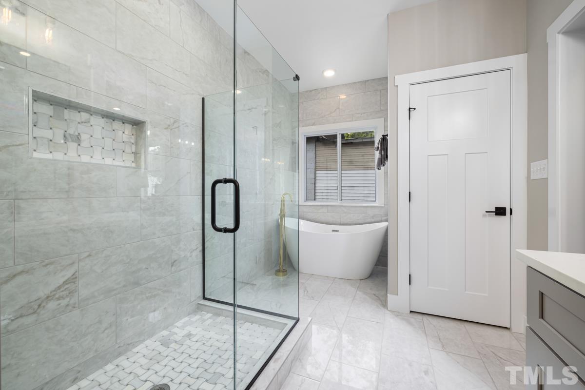 725 Church Street Raleigh, NC 27601 - Photo 14 of 21 a spacious bathroom with a granite countertop bathtub shower and a sink