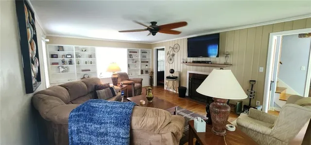 a living room with furniture a rug and a window