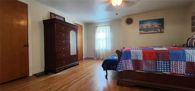 a bedroom with a bed and two windows