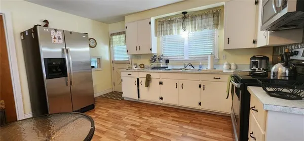 a kitchen with stainless steel appliances a refrigerator sink and cabinets