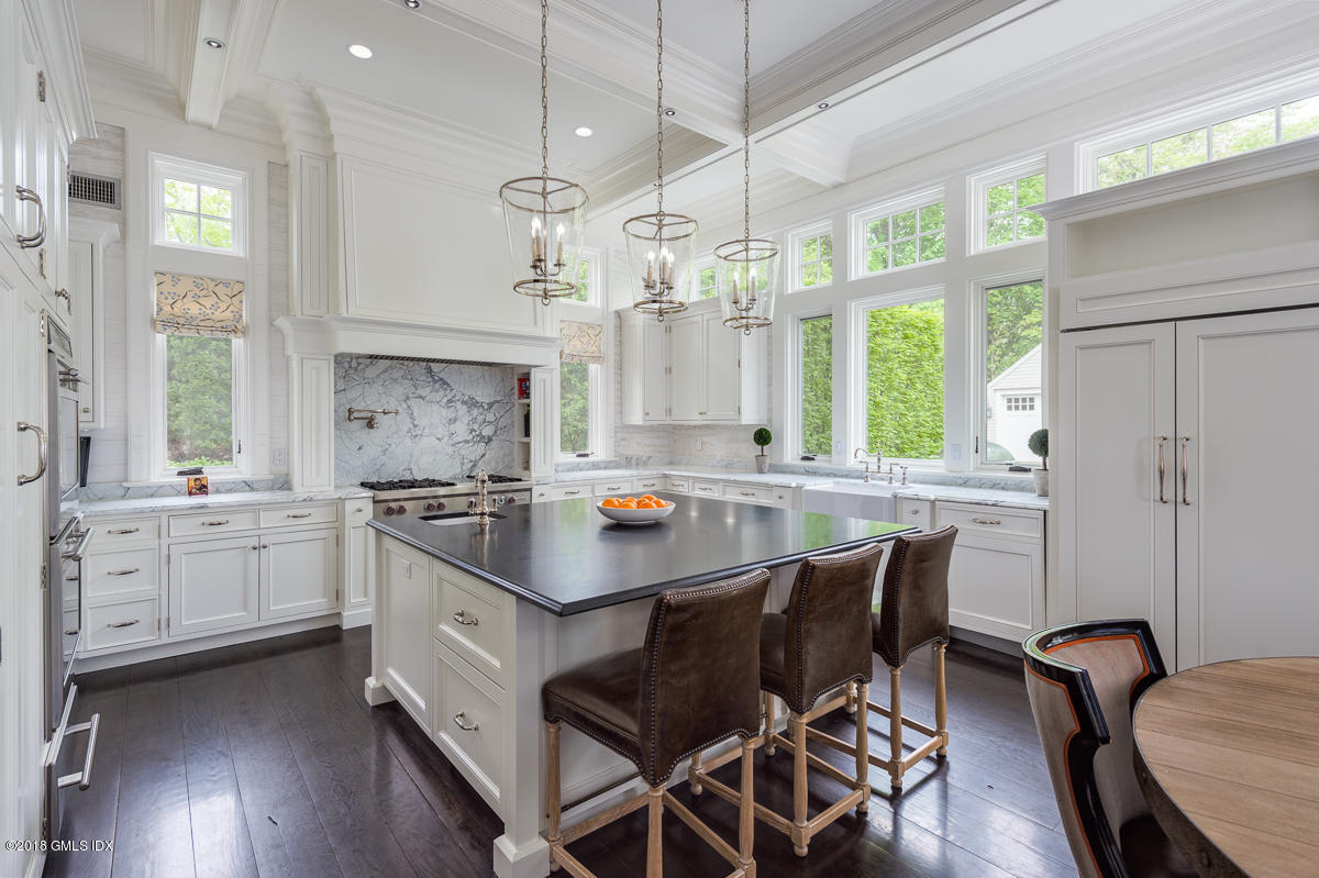 30 Club Road Riverside, CT 06878 - Photo 21 of 53 a kitchen with stainless steel appliances a table chairs and chandelier