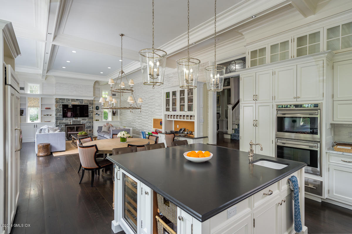 30 Club Road Riverside, CT 06878 - Photo 22 of 53 a kitchen with a sink a stove and chairs