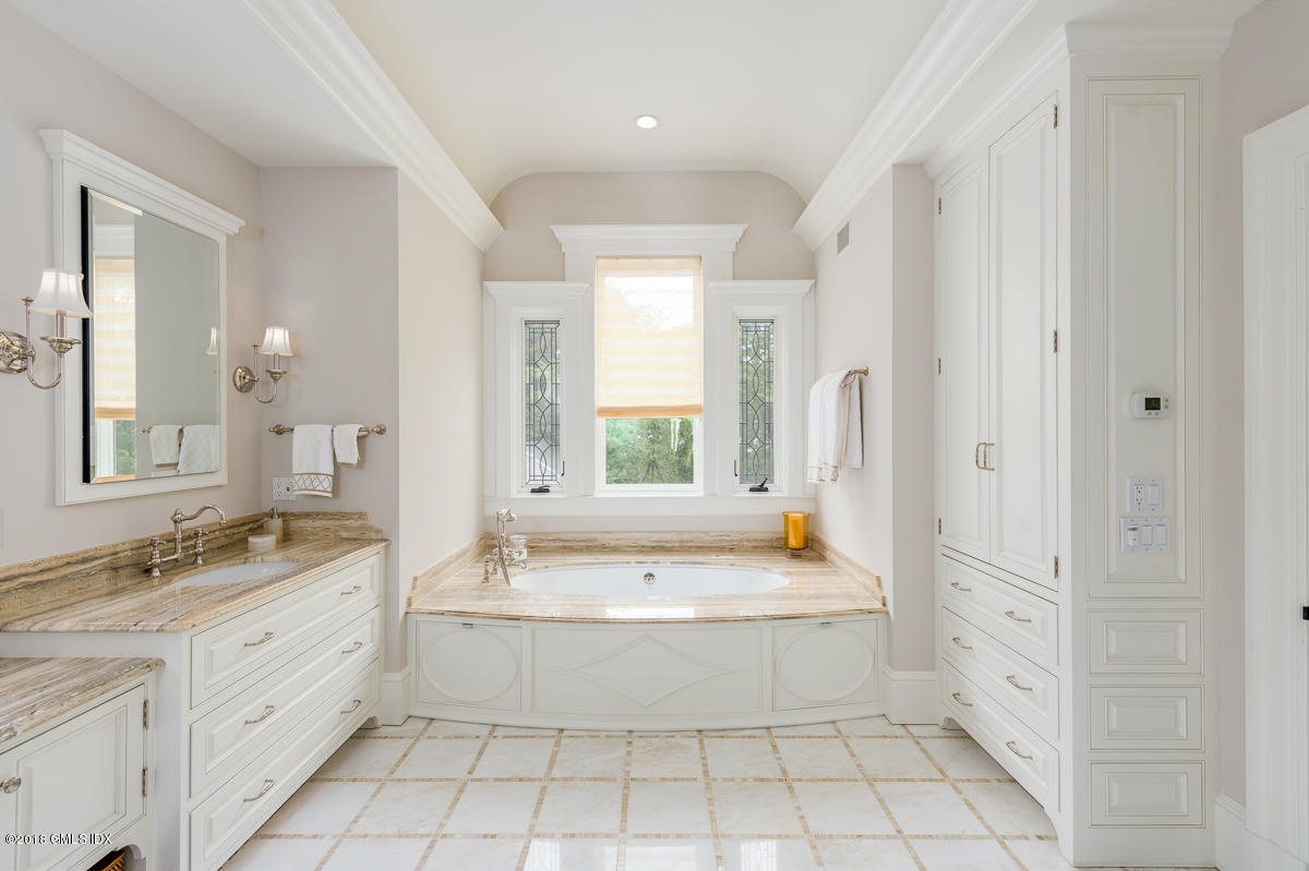 30 Club Road Riverside, CT 06878 - Photo 31 of 53 a bathroom with a granite countertop bathtub a sink and a mirror