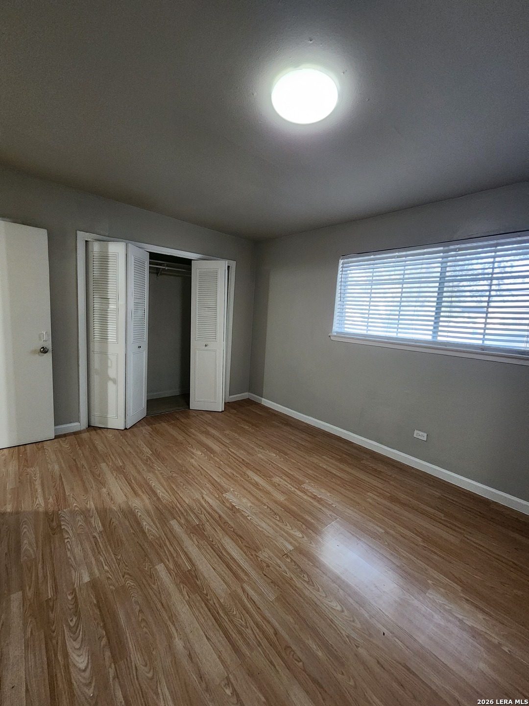 615 Vance Jackson Road, Unit 204 San Antonio, TX 78201 - Photo 14 of 14 an empty room with wooden floor and windows