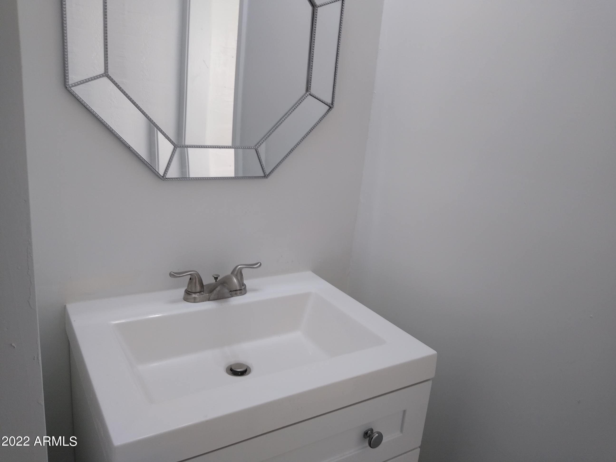 1629 East Pinchot Avenue Phoenix, AZ 85016 - Photo 2 of 9 a bathroom with a sink and mirror