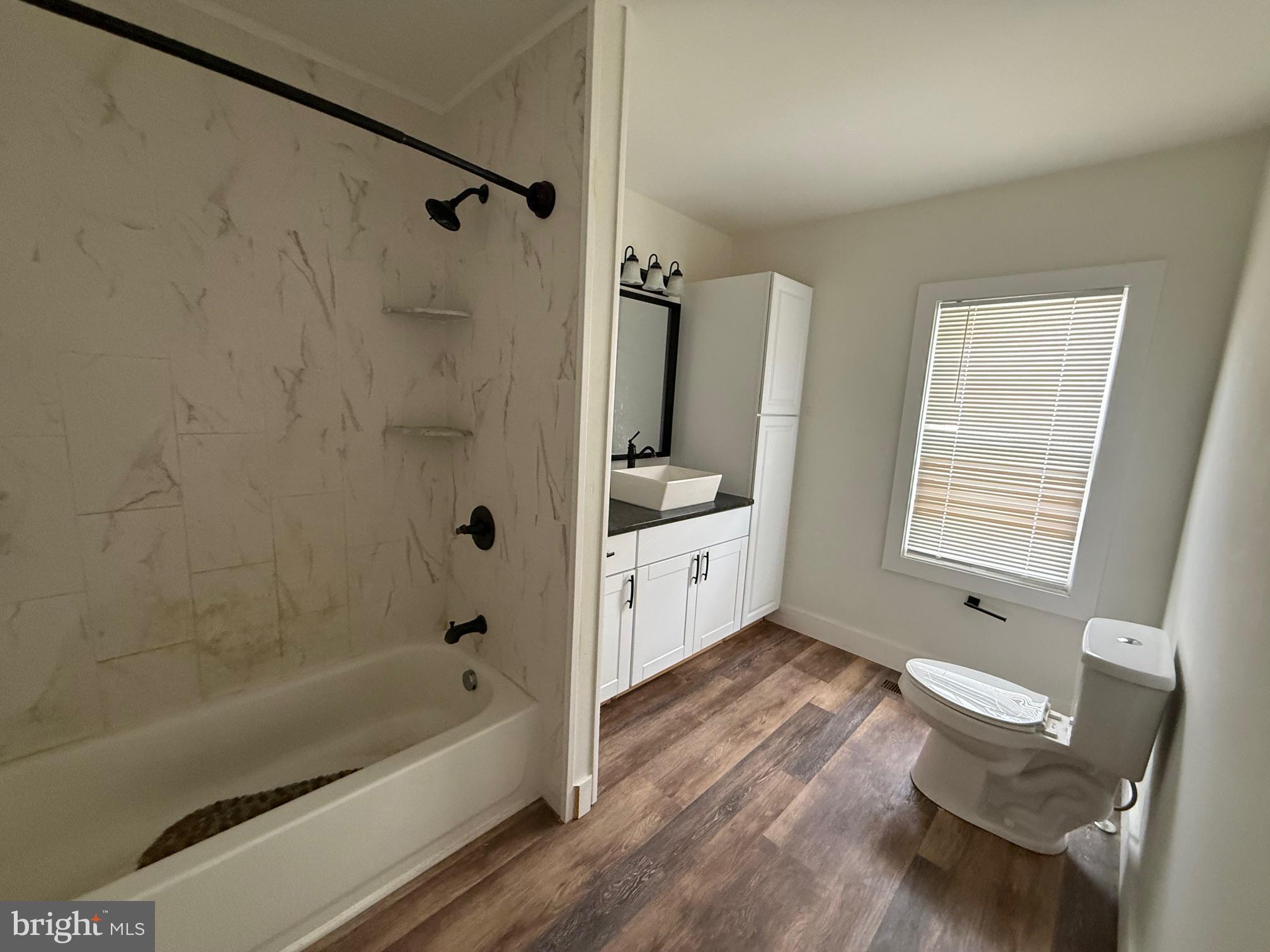 132 Walnut Street Westville, NJ 08093 - Photo 13 of 23 a bathroom with a bathtub sink and toilet