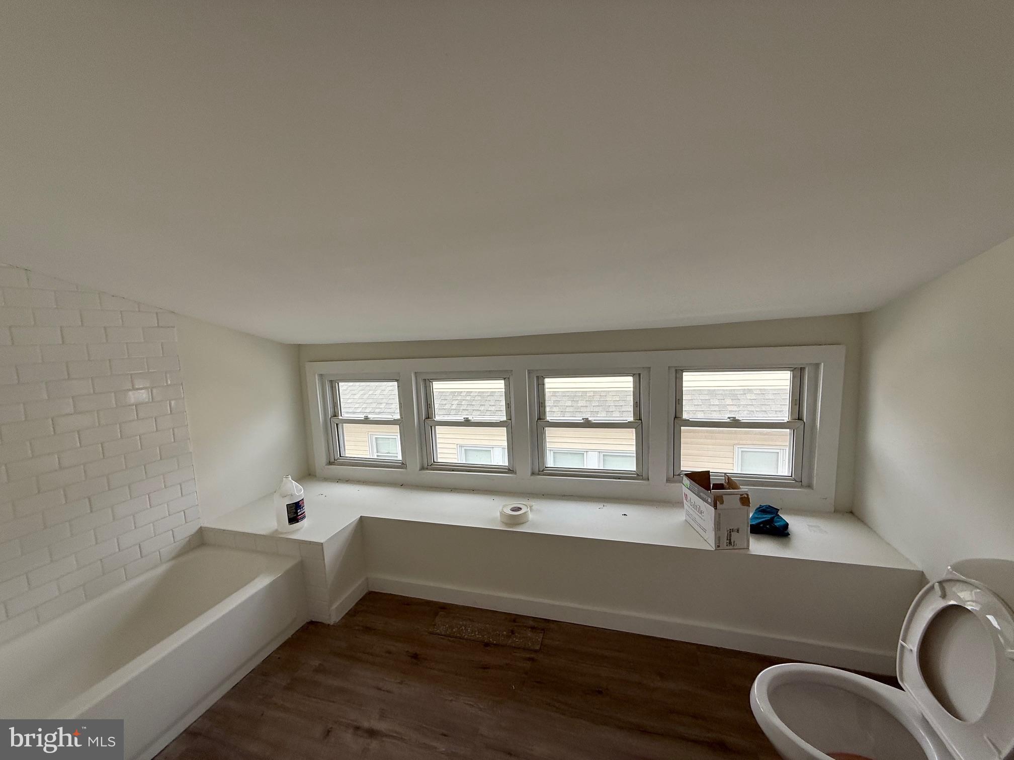 132 Walnut Street Westville, NJ 08093 - Photo 17 of 23 a bathroom with a granite countertop tub a sink and a large window
