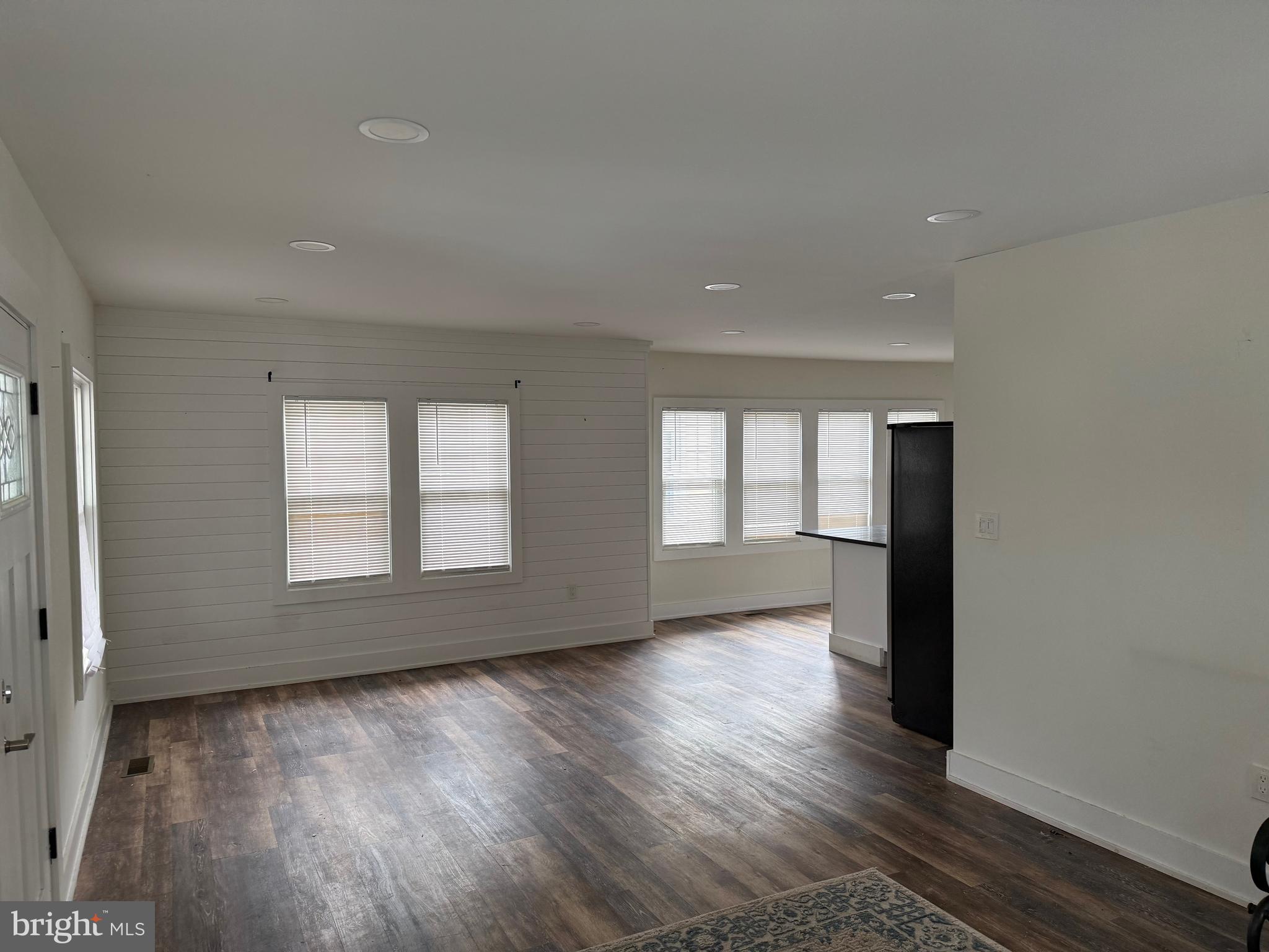 132 Walnut Street Westville, NJ 08093 - Photo 6 of 23 an empty room with wooden floor and windows