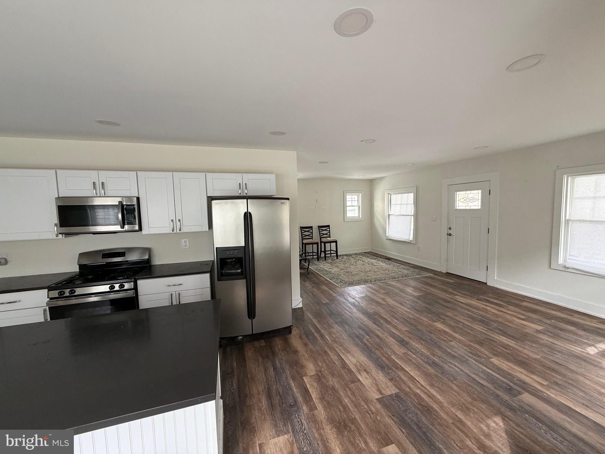 132 Walnut Street Westville, NJ 08093 - Photo 8 of 23 a kitchen with stainless steel appliances granite countertop a refrigerator a stove top oven a sink with granite countertops and cabinets