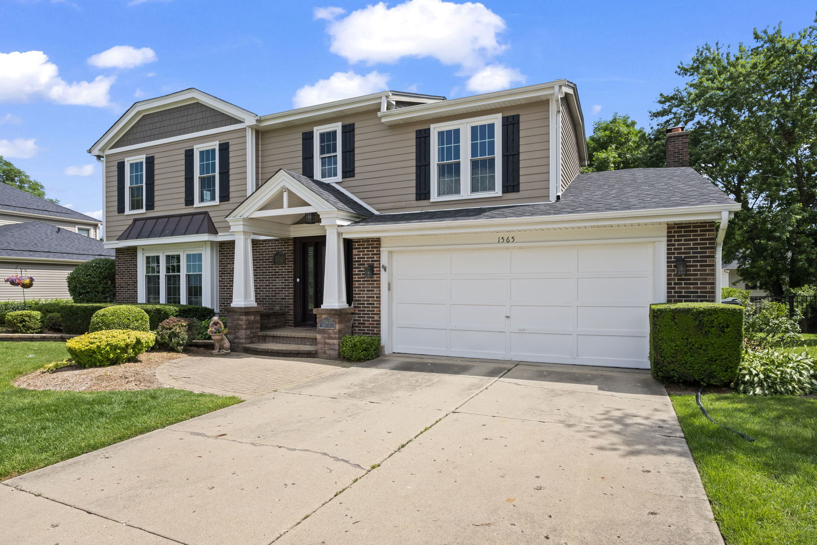 1565 Freeman Road Hoffman Estates, IL 60192 - Photo 2 of 46 a front view of a house with a yard and potted plants
