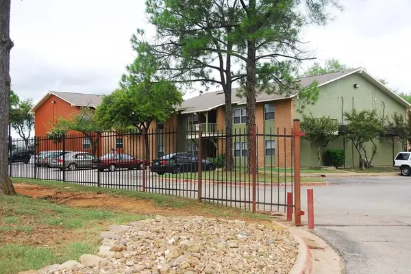 a view of a house with a small yard and wooden fence