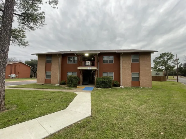 a view of a house with a yard and garage