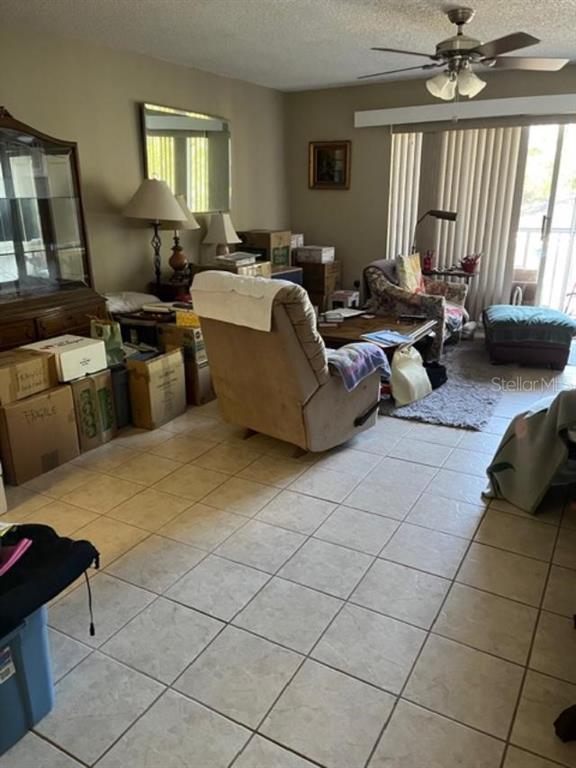 330 Promenade Drive, Unit 206 Dunedin, FL 34698 - Photo 16 of 31 a living room with furniture and a large window