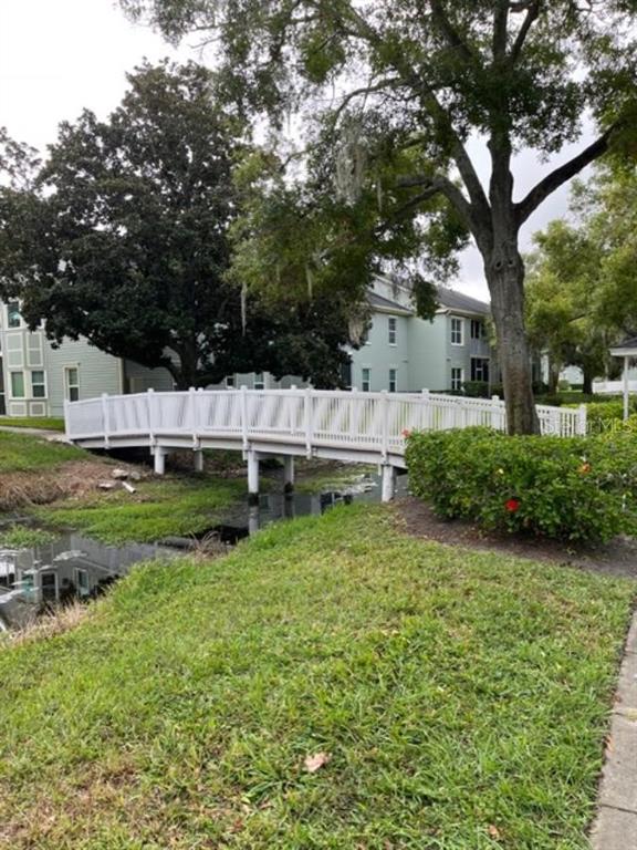 330 Promenade Drive, Unit 206 Dunedin, FL 34698 - Photo 5 of 31 a view of a house with a yard