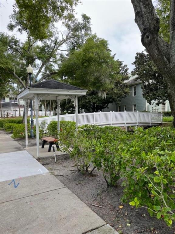 330 Promenade Drive, Unit 206 Dunedin, FL 34698 - Photo 6 of 31 a view of a house with backyard sitting area and garden