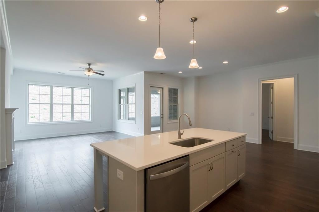 5865 Overlook Ridge East, Unit 105 Suwanee, GA 30024 - Photo 2 of 40 Picture is representative. This is photo of Avery Plan decorated model kitchen/breakfast/family room