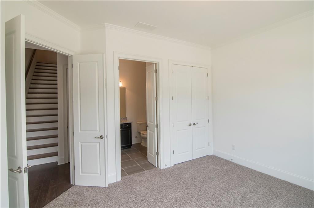 5865 Overlook Ridge East, Unit 105 Suwanee, GA 30024 - Photo 19 of 40 Custom closet system in "HIS" closet
