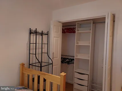 a view of walk in closet with empty racks