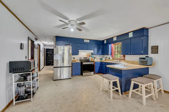 a kitchen with stainless steel appliances wooden cabinets and granite counter tops