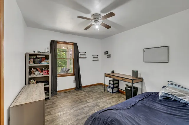 a bed room with a bed and a book shelf