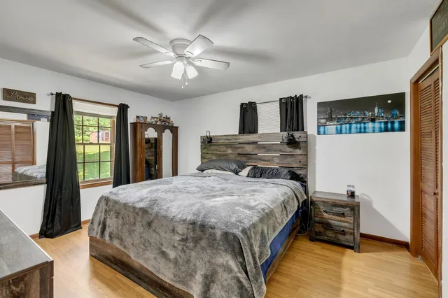 a bedroom with a large bed and a chandelier