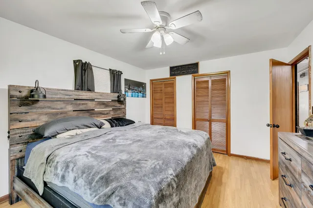 a bedroom with a large bed and a flat tv screen on dresser