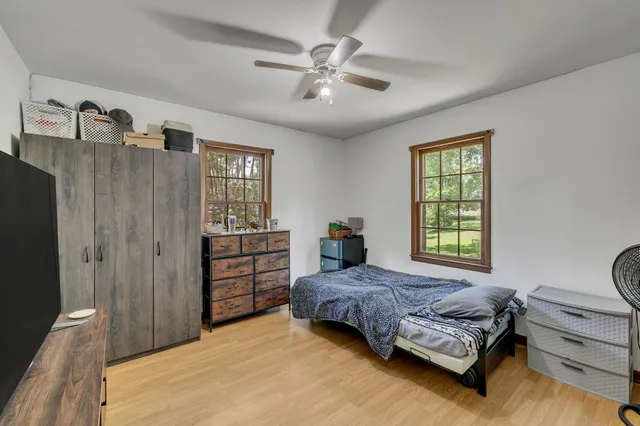 a bedroom with a bed and a window