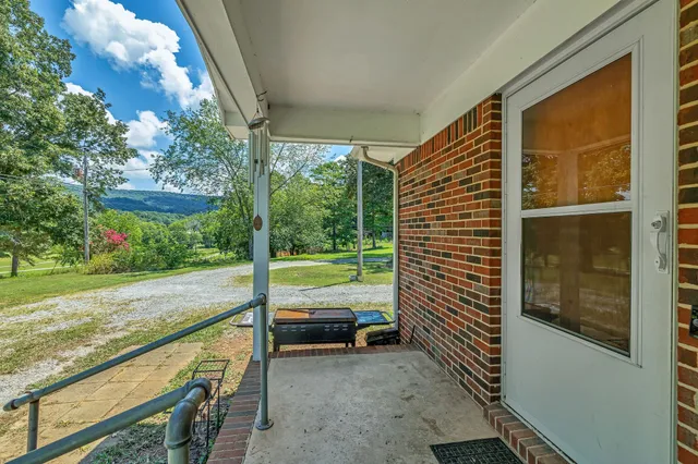 a view of a porch with furniture and garden