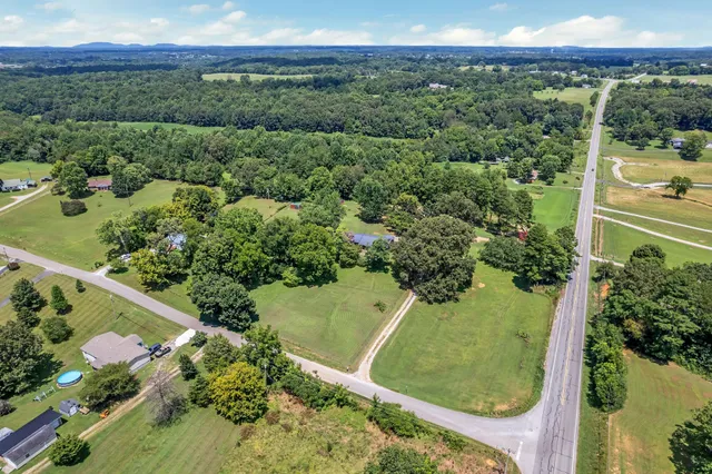 an aerial view of a residential houses covered in trees