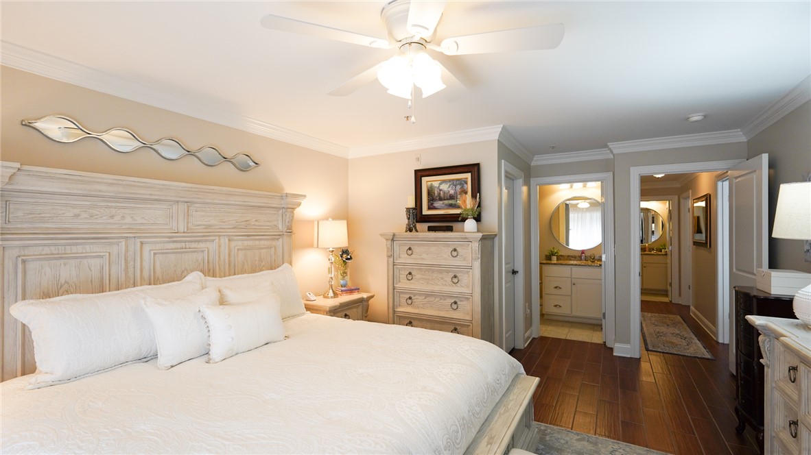 303 Lookover Drive Anderson, SC 29621 - Photo 32 of 46 Relax in this inviting primary bedroom featuring rich hardwood floors and elegant crown molding.