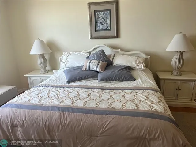 a bedroom with a bed and a lamp