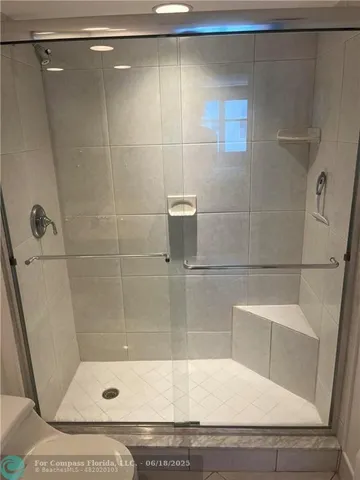 a bathroom with a shower and a sink