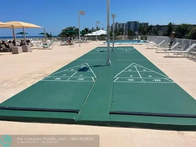 a view of swimming pool with outdoor seating and yard