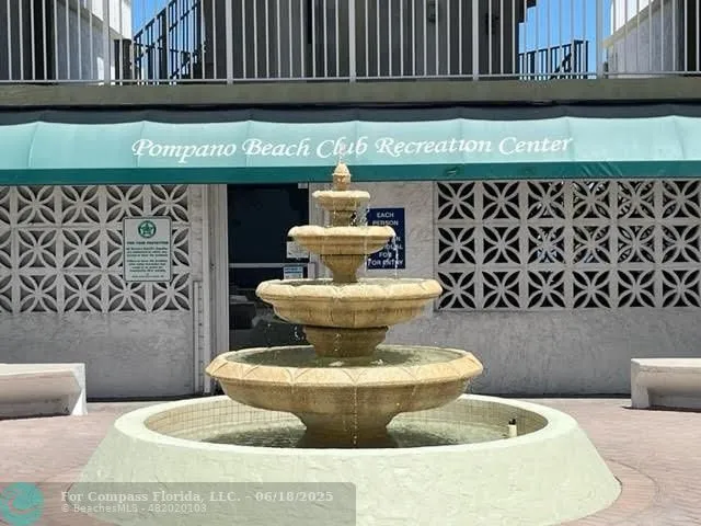 a living room with furniture and a dining table